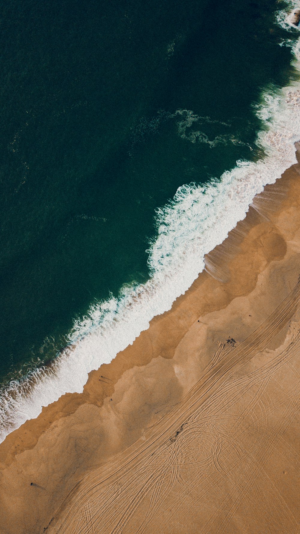 a bird's eye view of a beach and ocean