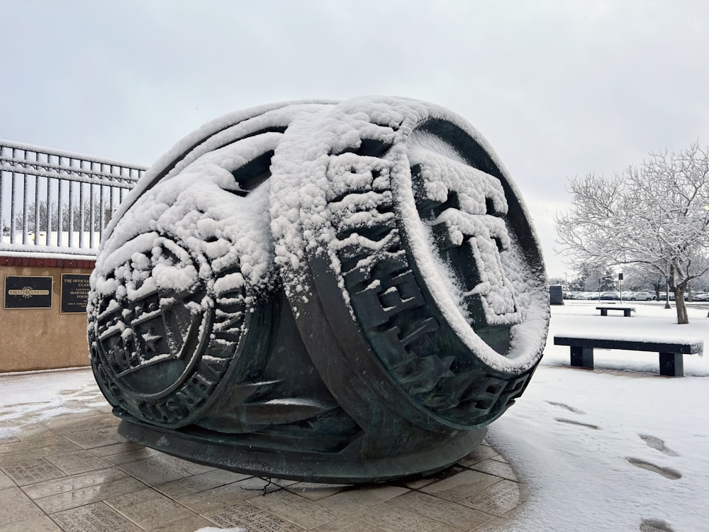a snow covered tire sculpture in front of a building