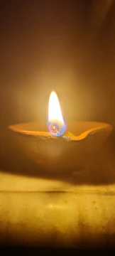 Earthen pots filled with fresh ghee glowing softly in natural light.