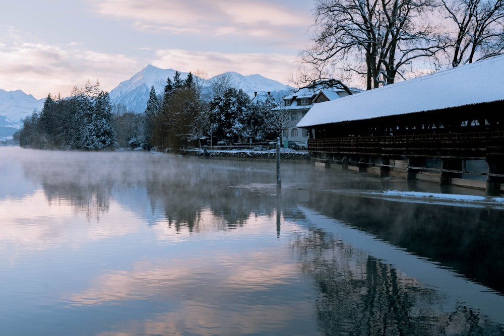 a body of water surrounded by snow covered mountains