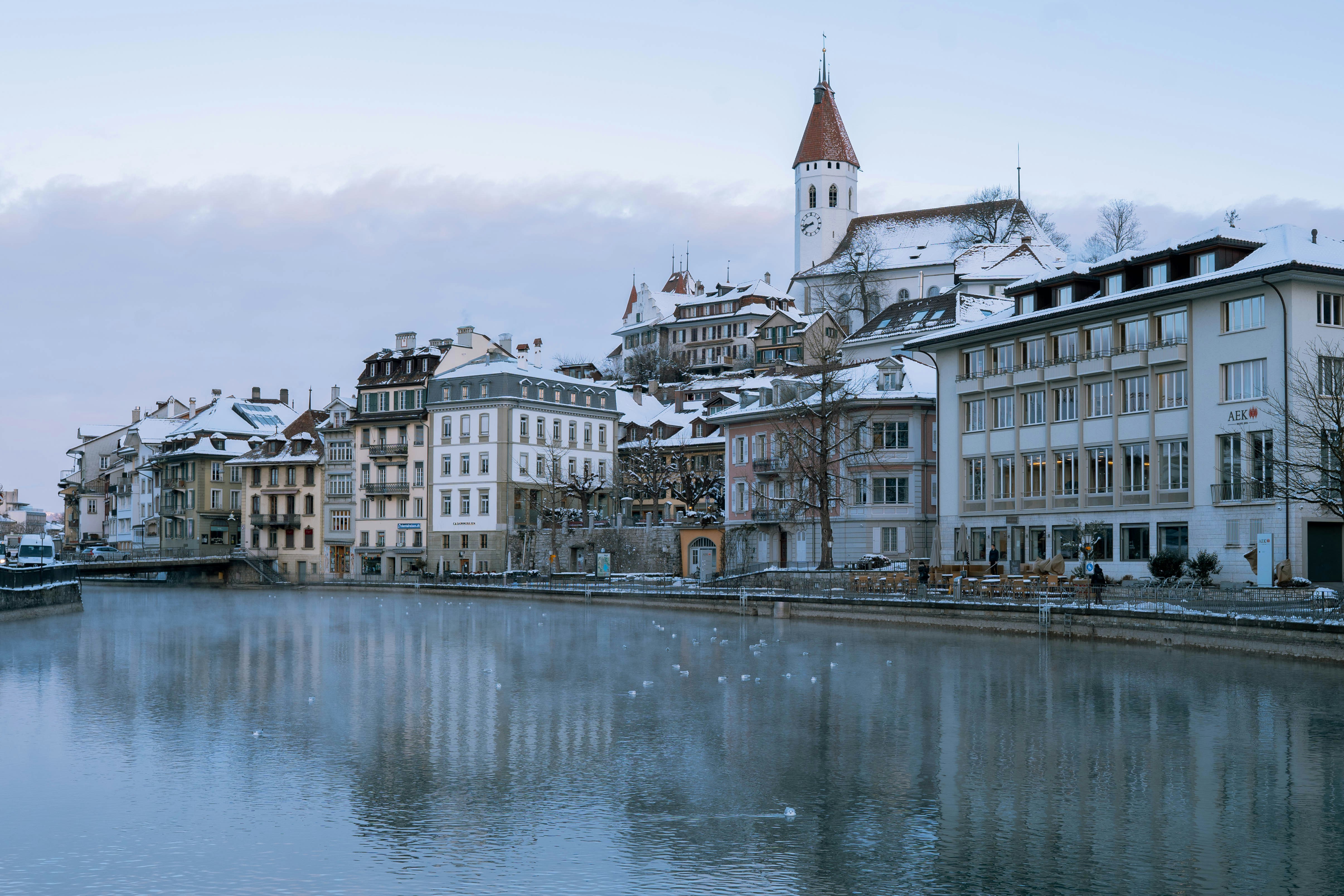 a body of water surrounded by buildings and a clock tower