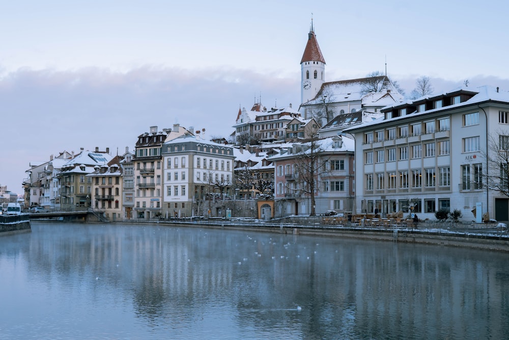 a body of water surrounded by buildings and a clock tower