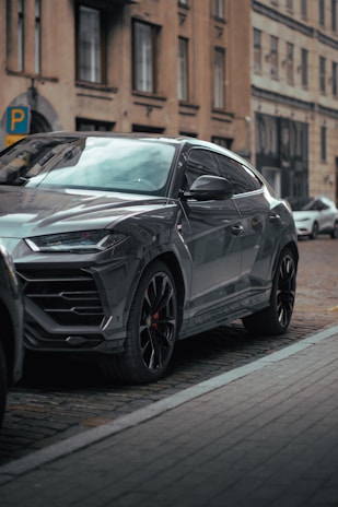 A stylish SUV fitted with rugged alloy wheels and all-terrain tyres on a city street.