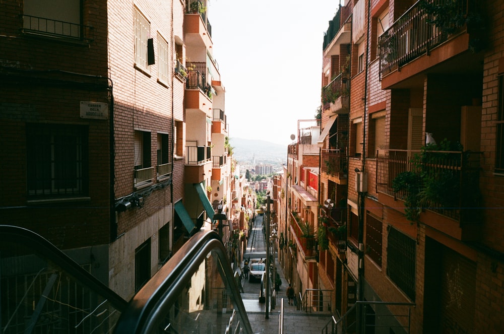 a narrow city street with people walking down it