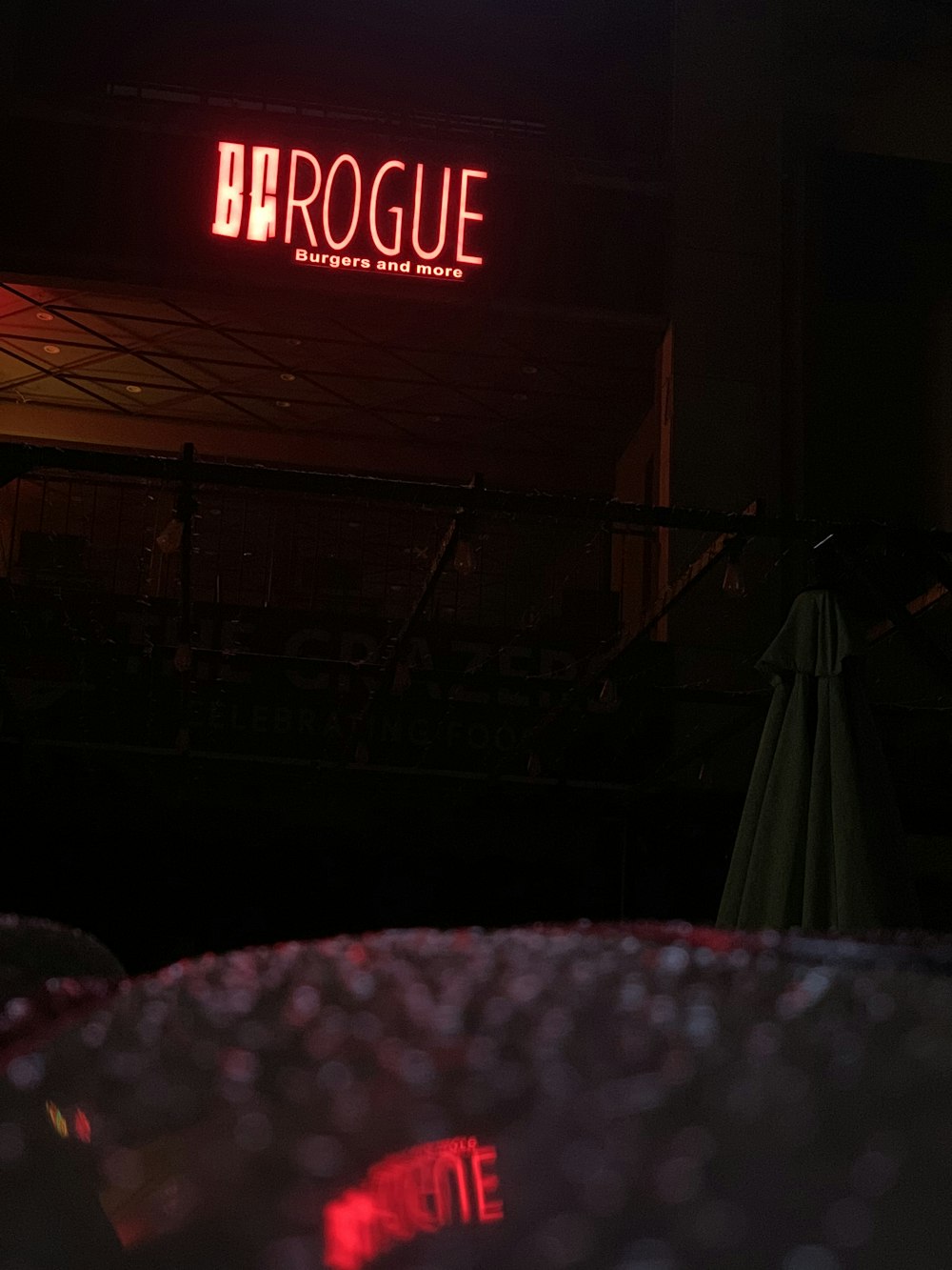 a neon sign that reads broogue in a dark room