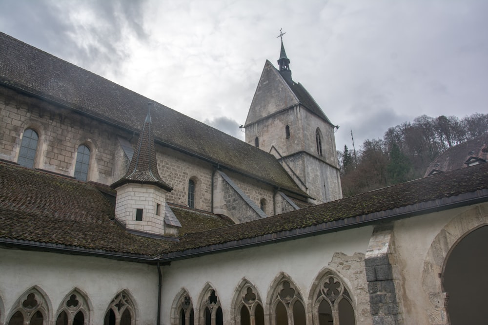 an old church with a steeple on a cloudy day