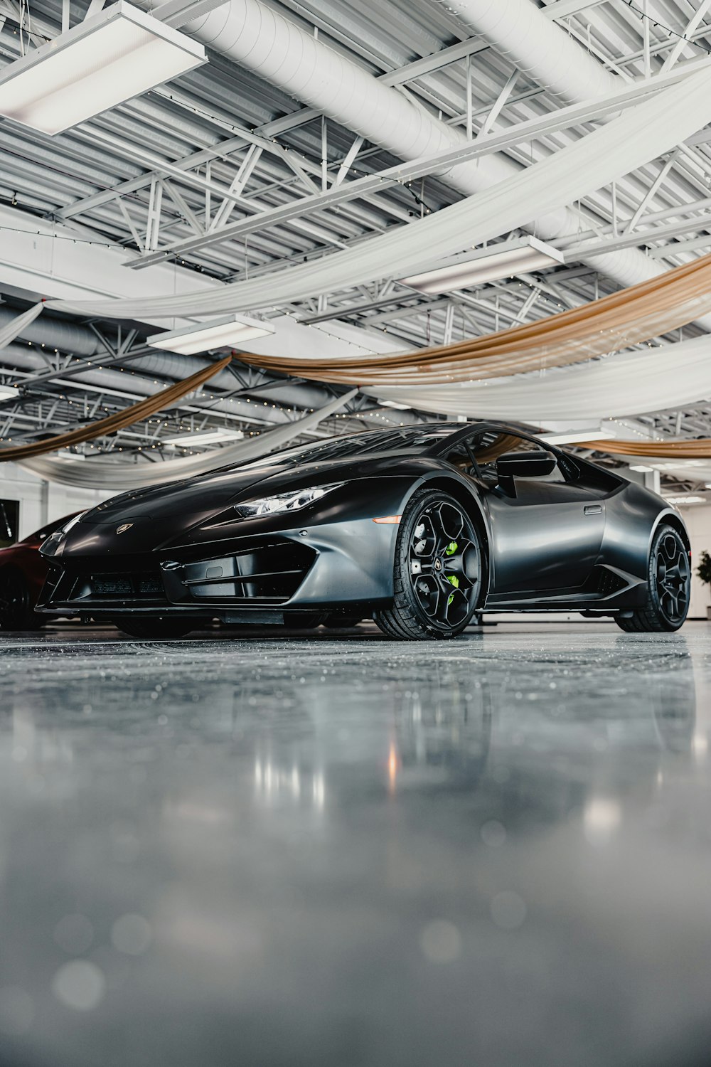 A black sports car parked in a garage photo – Free Machine Image on Unsplash