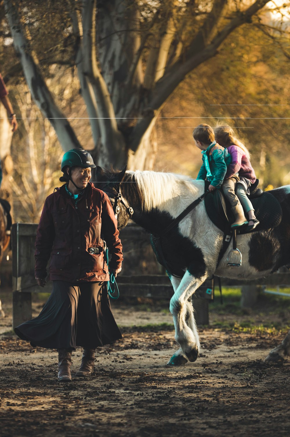 a man and a little girl riding on the back of a horse