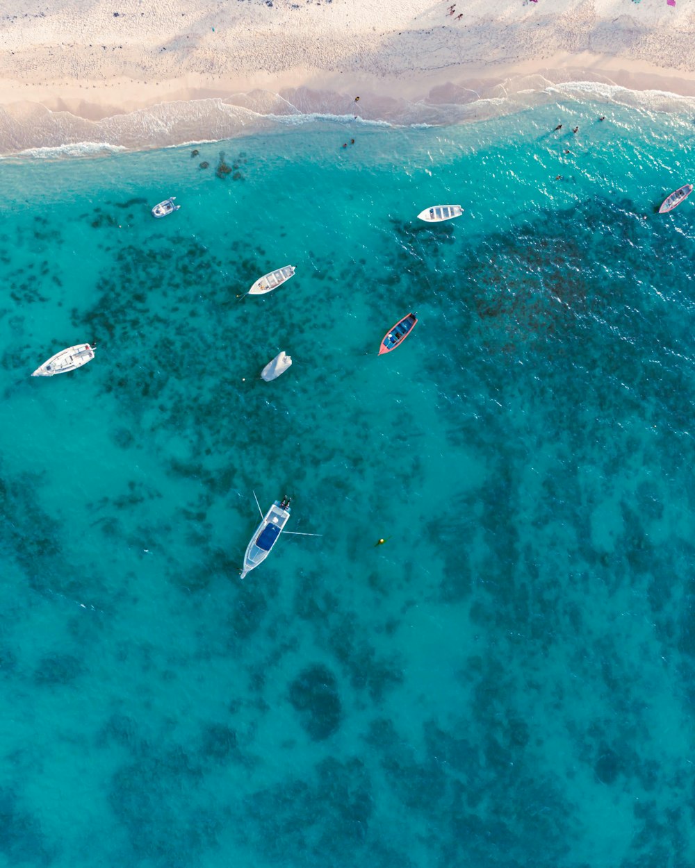 a group of boats floating on top of a body of water