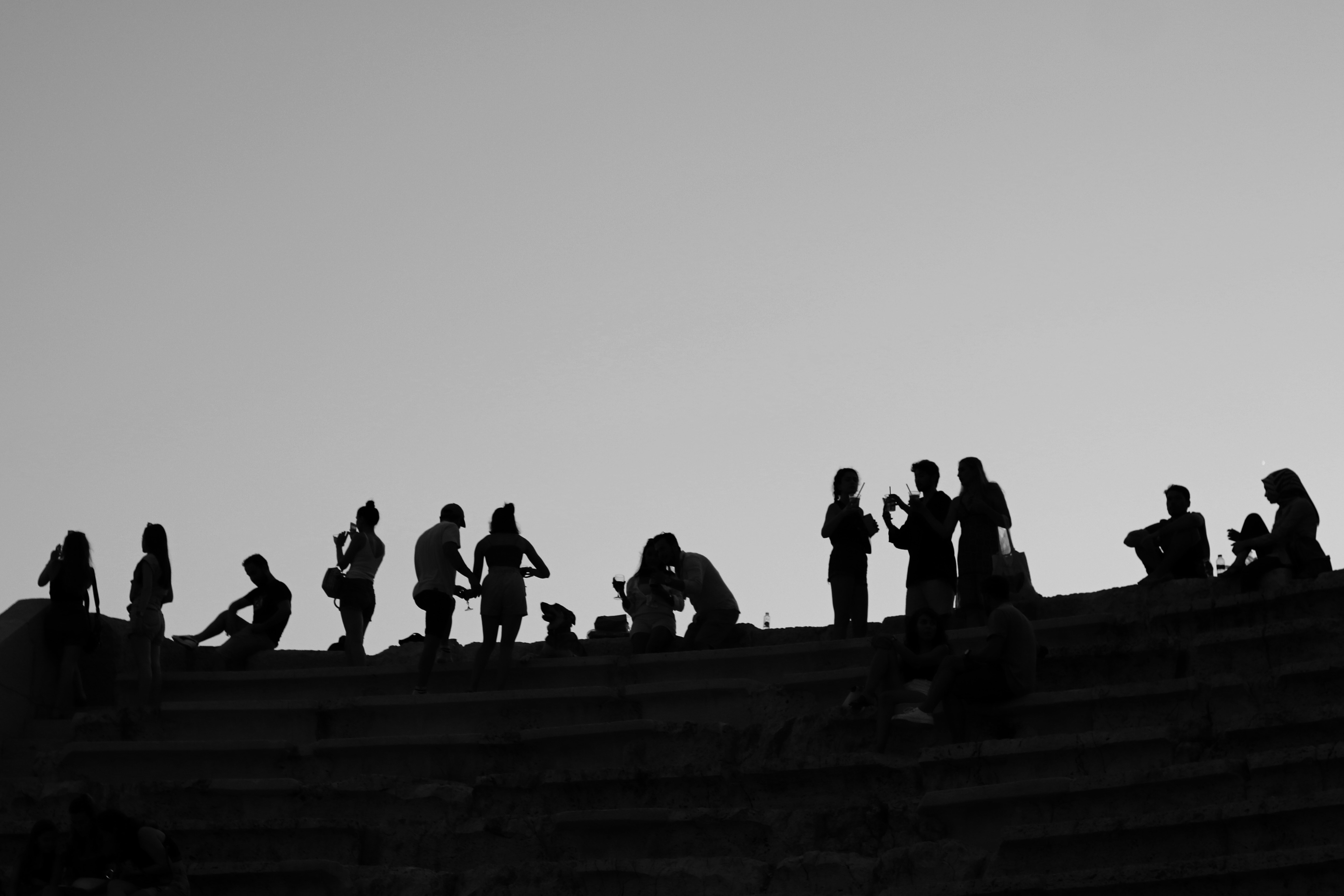 a group of people standing on top of a stone wall