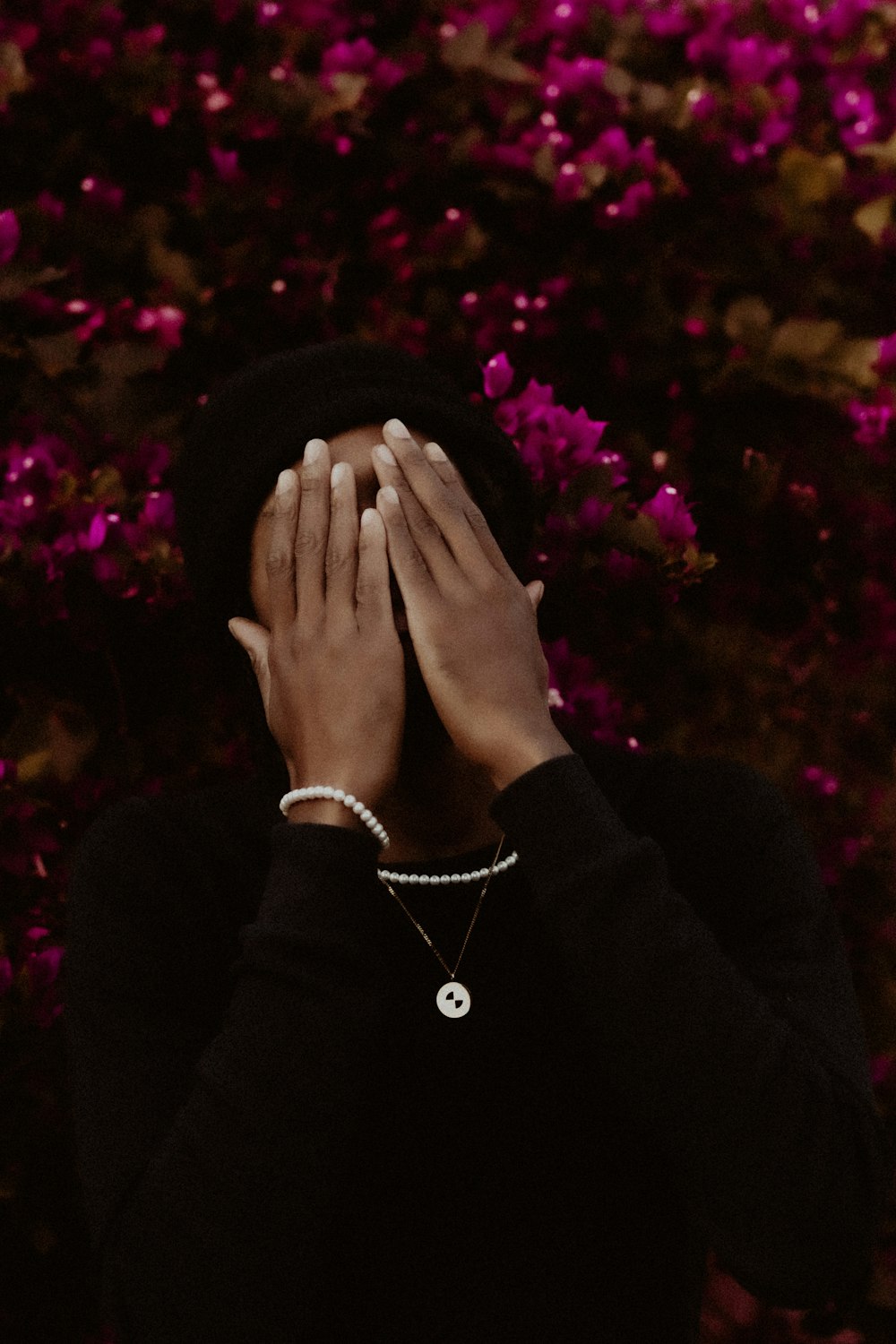 a woman covering her face with her hands