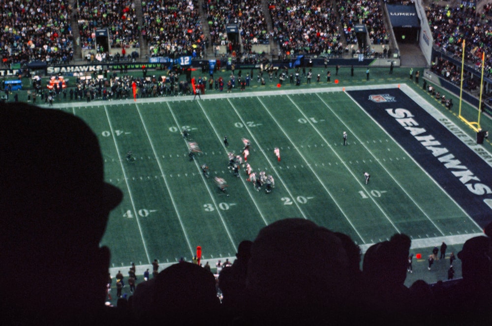 a football game is being played at a stadium