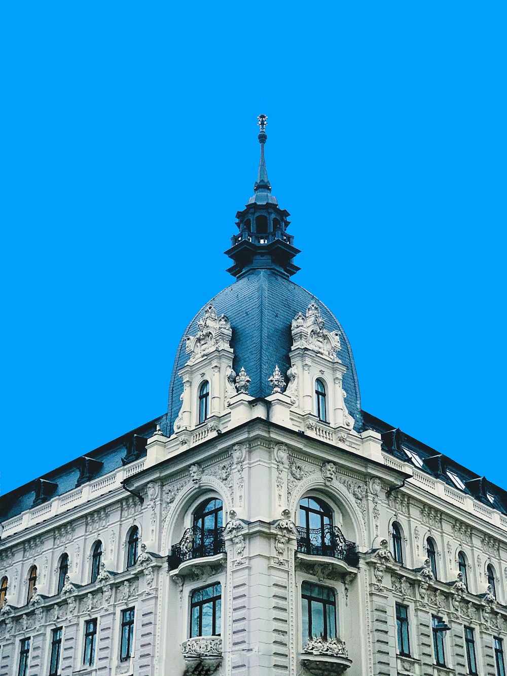 a large white building with a clock on the top of it