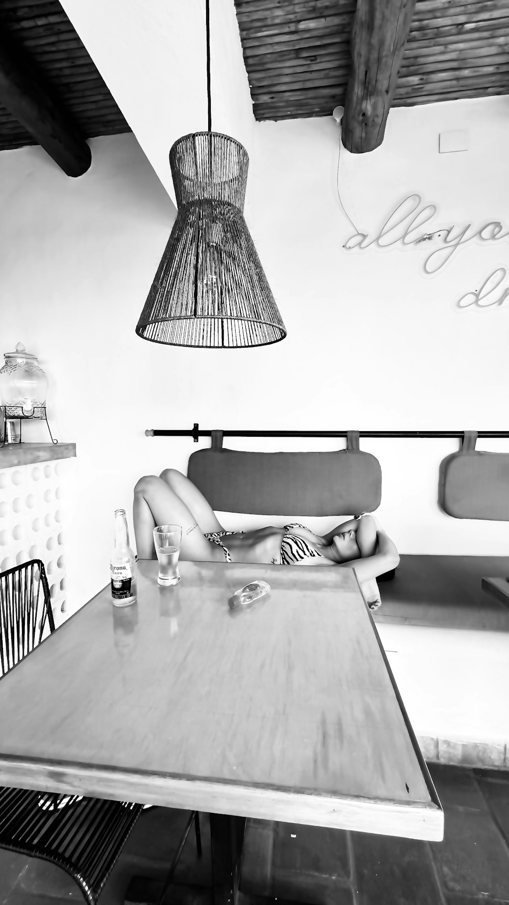 a woman laying on a table in a restaurant