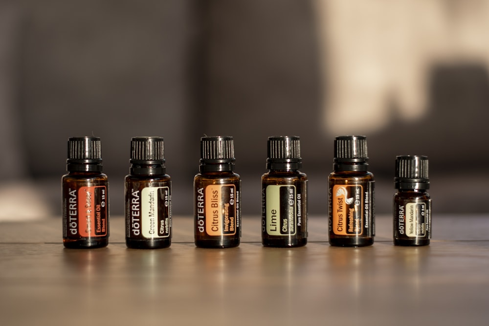 a row of bottles of essential oils on a table