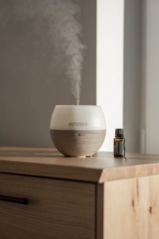 a humidifier sitting on top of a wooden dresser