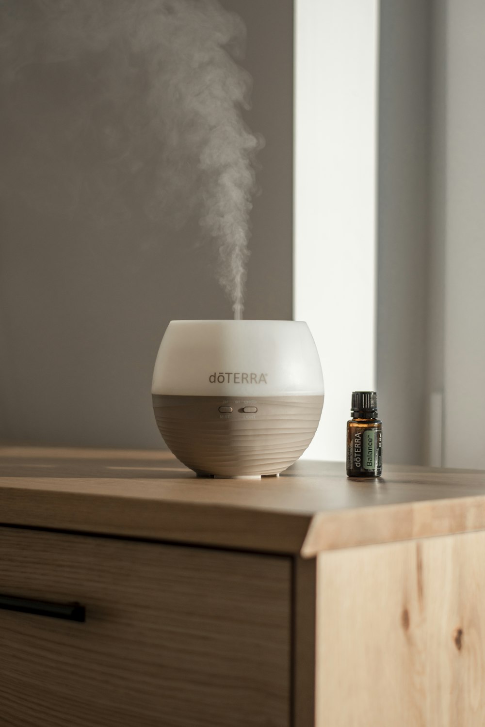 a humidifier sitting on top of a wooden dresser