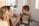 Smiling mother holding a bottle of Verdanido supplements with her young child in a bright kitchen.