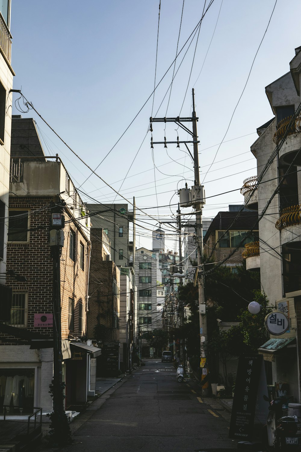 a city street lined with buildings and power lines