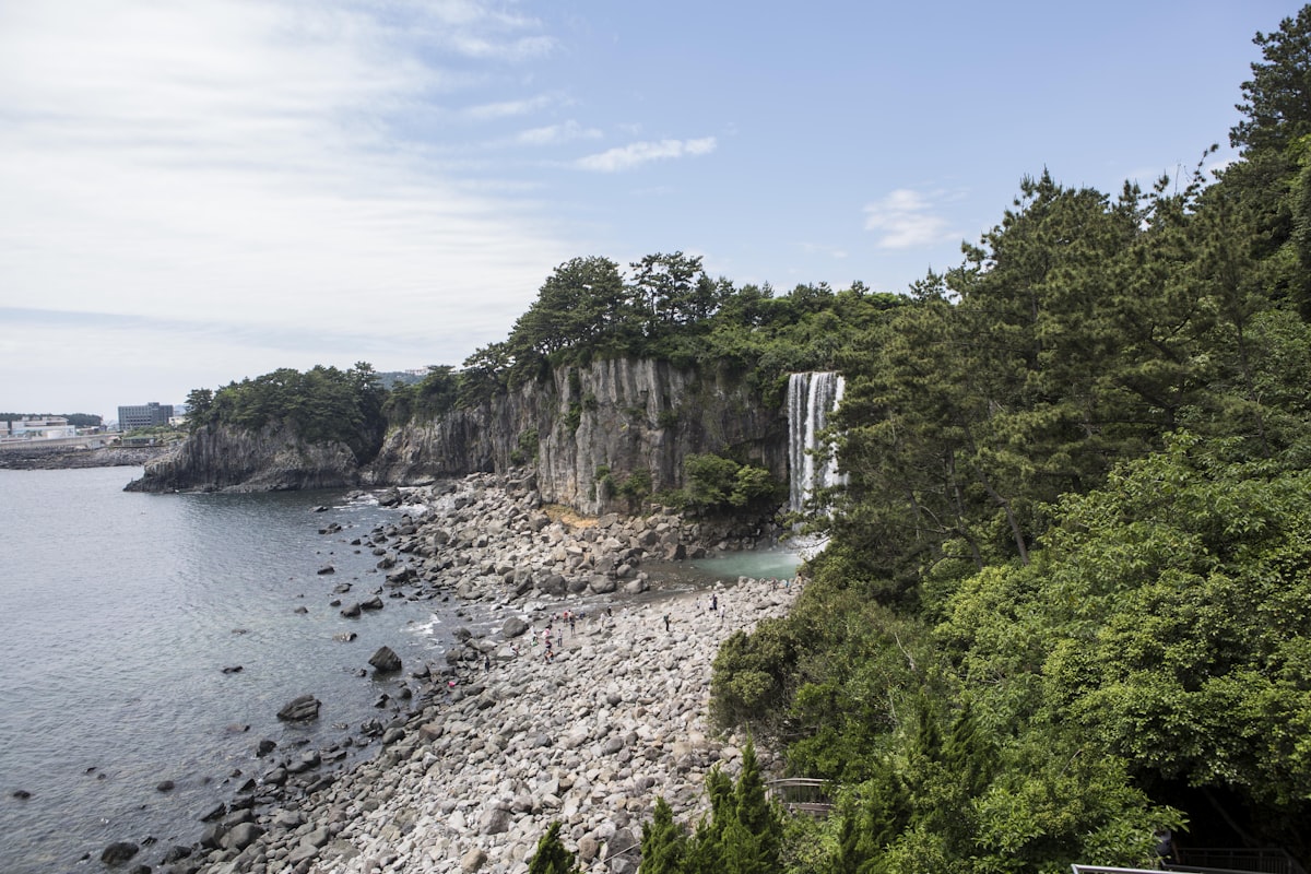 February Jeju coastal black basalt rocks with winter sea spray