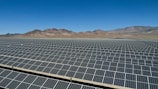 a large array of solar panels in a desert
