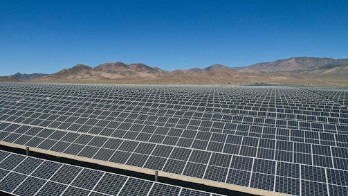 a large array of solar panels in a desert