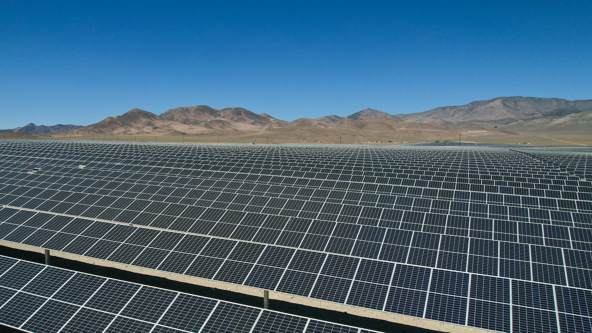 a large array of solar panels in a desert