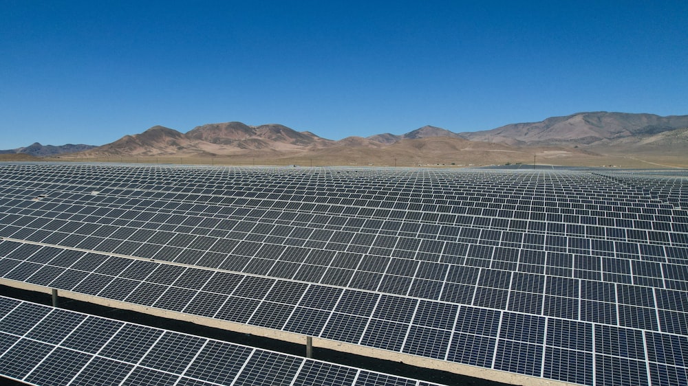 a large array of solar panels in a desert