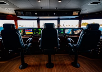 two seats in front of a large screen tv