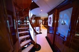 a staircase in a large room with a lot of windows