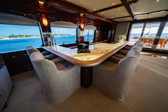 Elegant office space with a view of Antigua harbor, featuring subtle gold accents and a sleek black and navy color scheme.