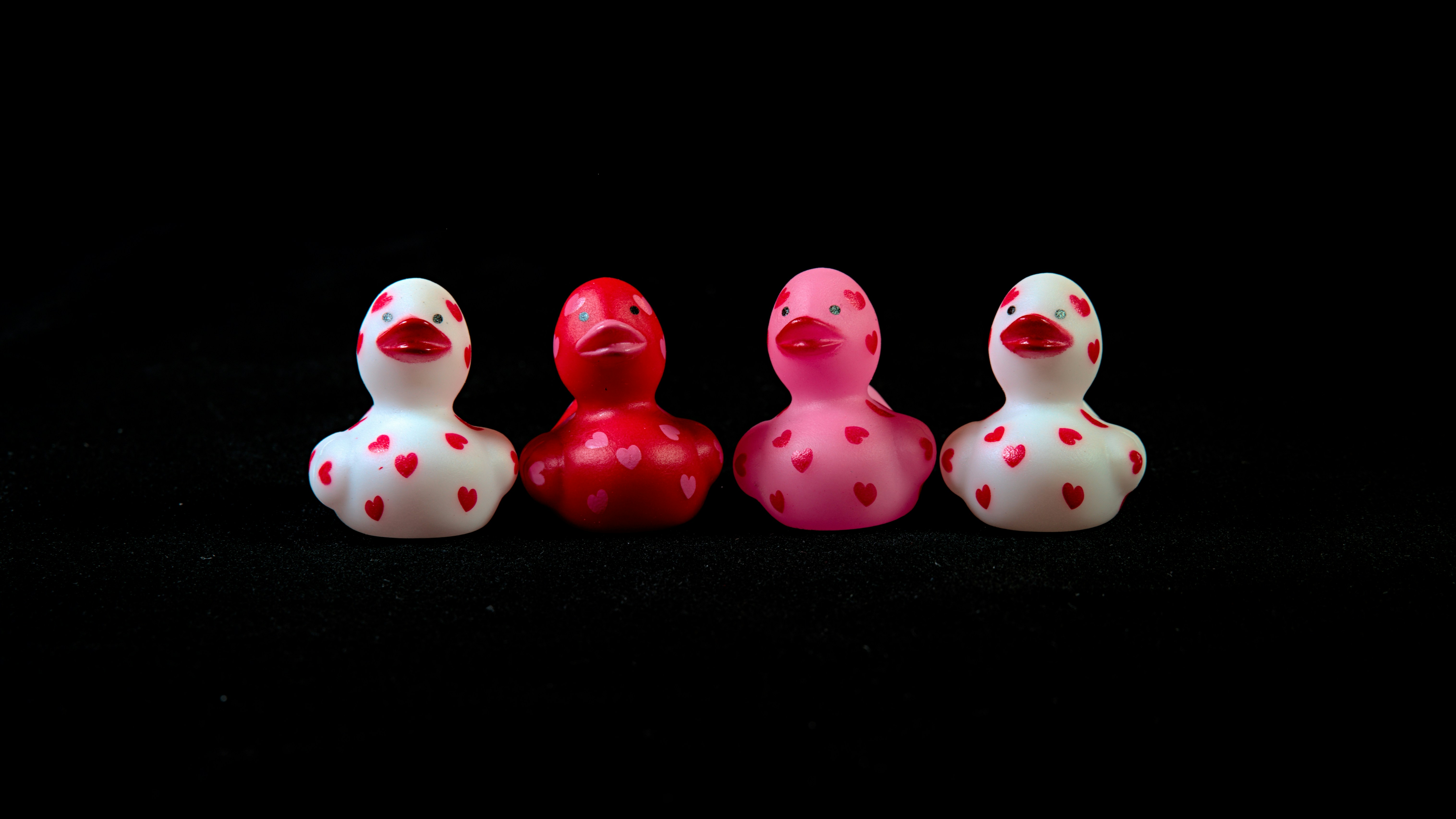 A group of three rubber ducks sitting next to each other photo – Free ...
