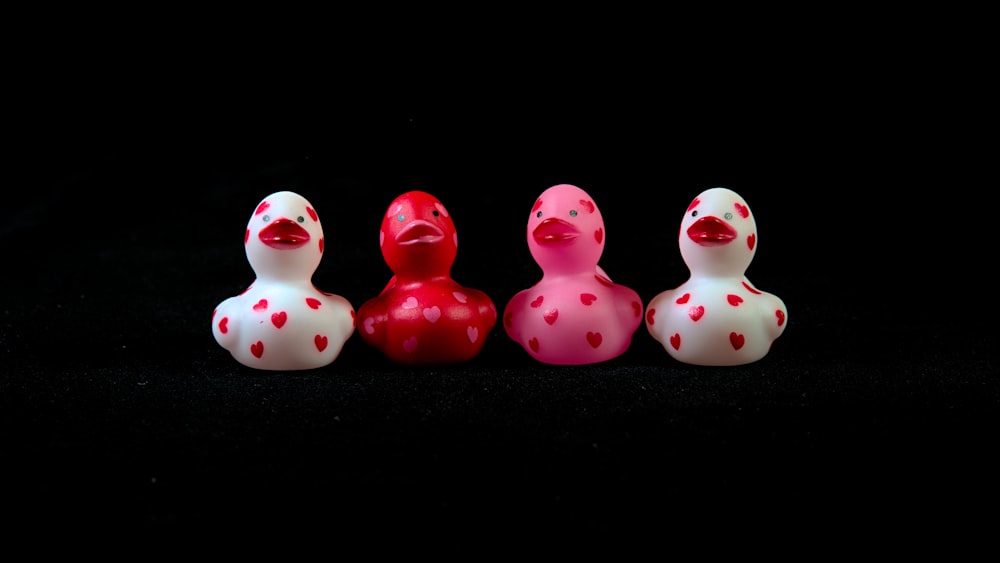 a group of three rubber ducks sitting next to each other