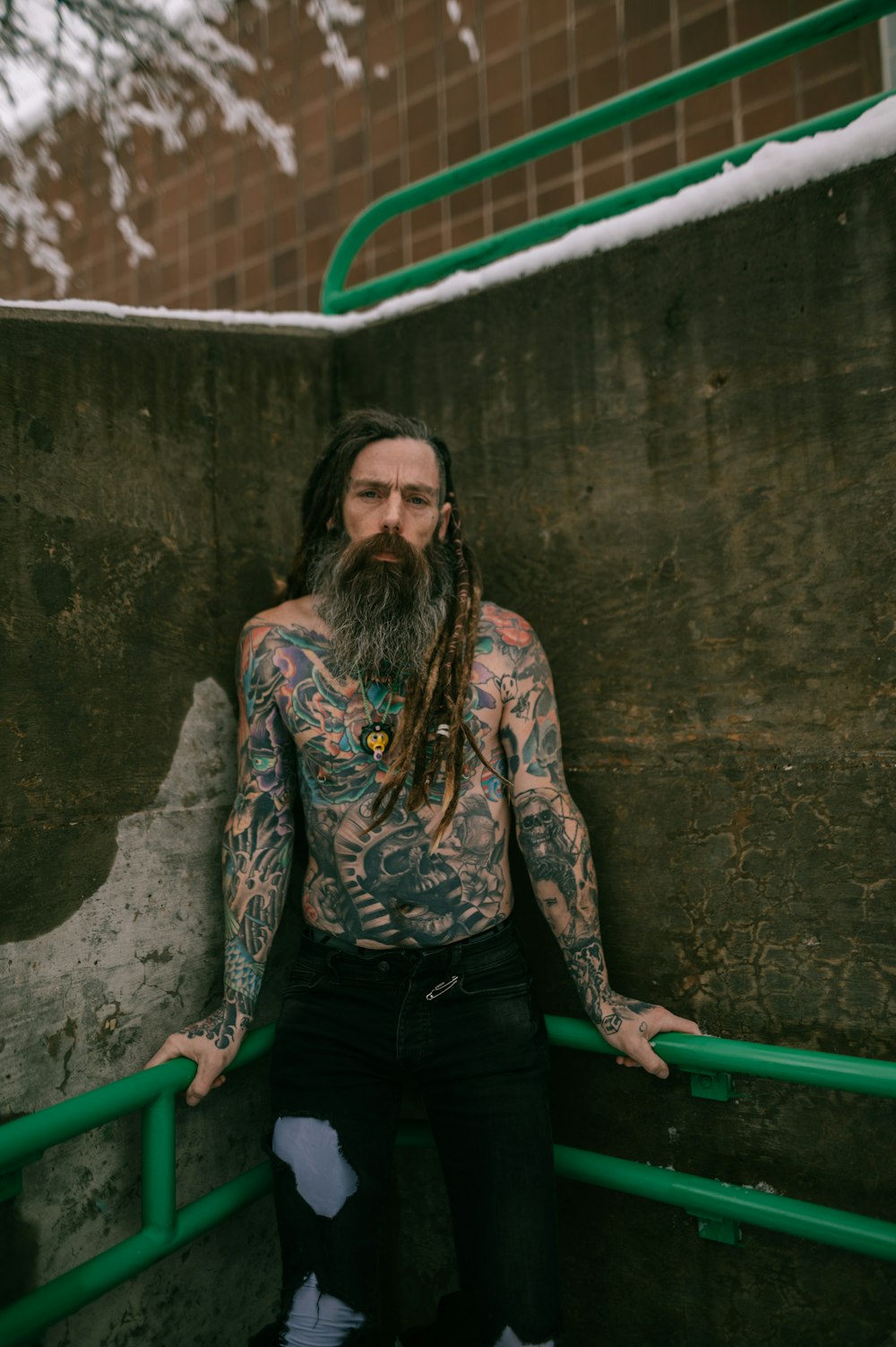 a man with long hair and a beard with tattoos