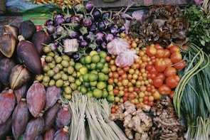 Colorful assortment of organic fruits and vegetables arranged in baskets at a market stall.
