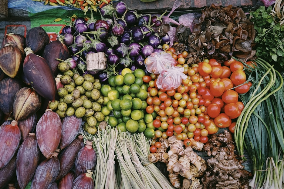 Fresh assortment of colorful fruits and vegetables neatly arranged on a market stall
