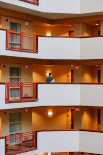A close-up of a frustrated person holding apartment rental documents in a busy urban setting.