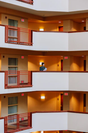 A close-up of a frustrated person holding apartment rental documents in a busy urban setting.