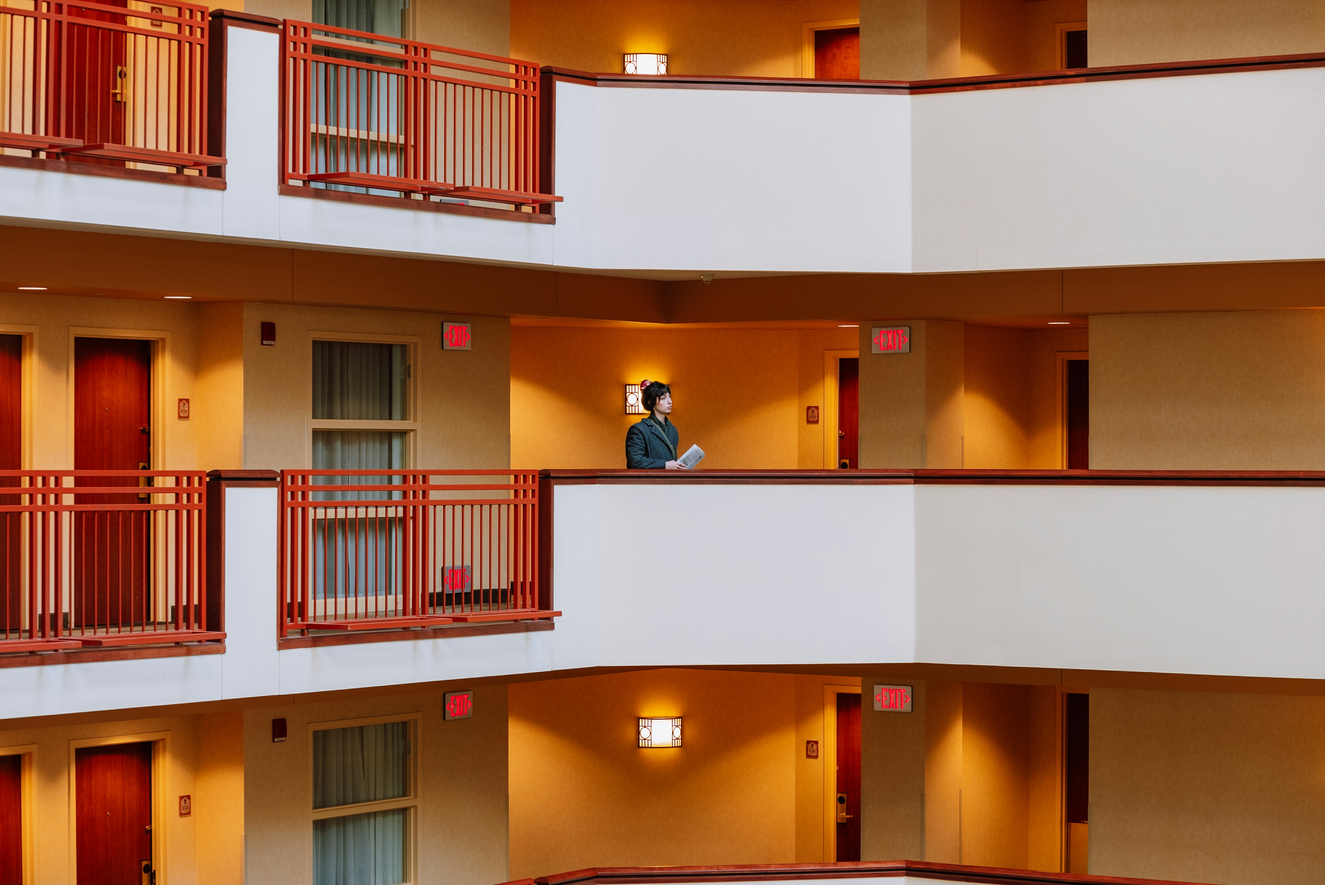 a person standing on a balcony of a building, 