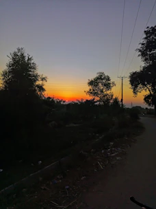 Sunset over a DTCP approved commercial land parcel with smooth road access.