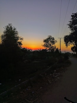 Sunset over a spacious rural terrain with visible boundary markers.