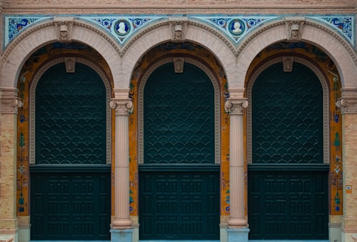 a couple of green doors sitting next to each other