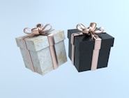 two black and white boxes with gold bows
