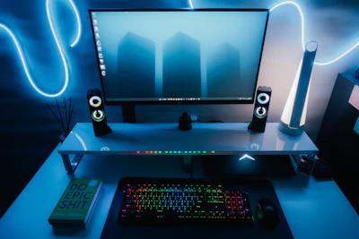a computer desk with a keyboard and speakers