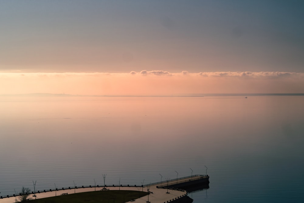 a large body of water sitting under a cloudy sky