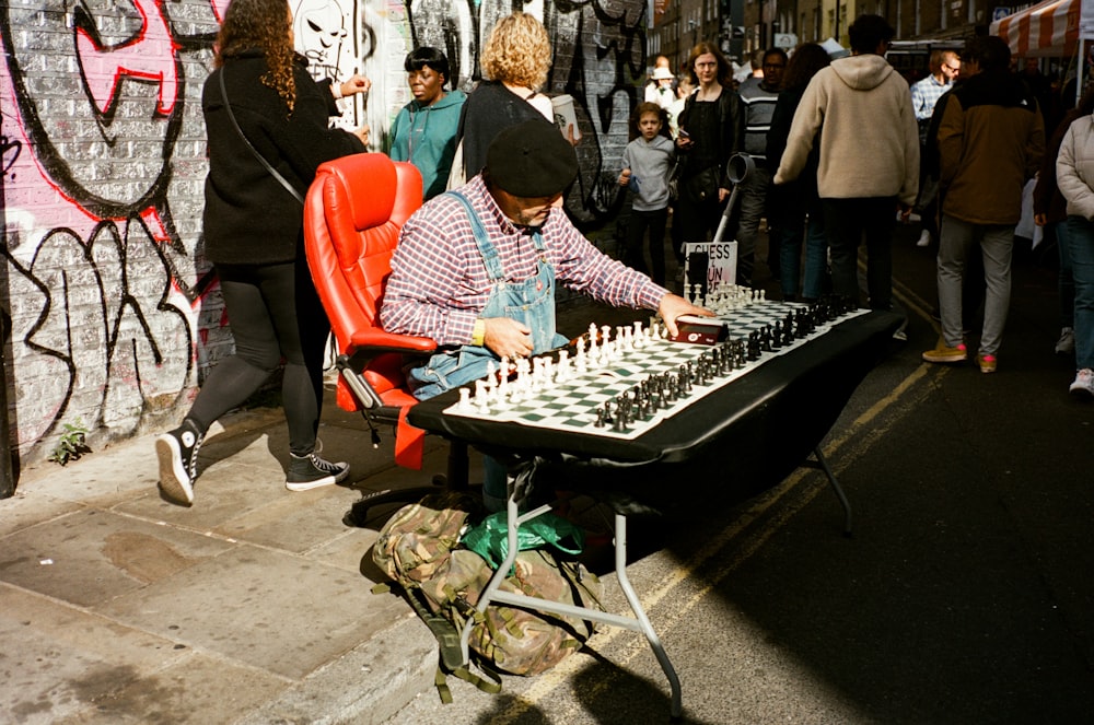 a man playing a game of chess on a street