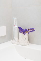 a toothbrush and a tube of toothpaste on a counter