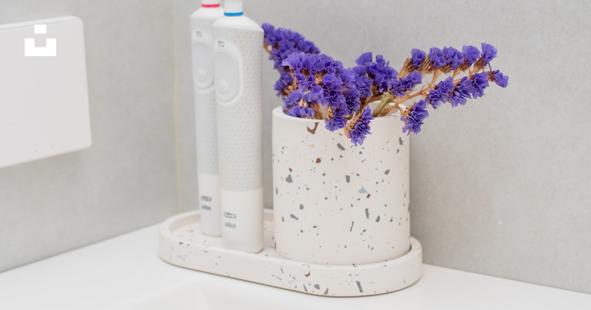 A toothbrush and a tube of toothpaste on a counter photo – Free Window ...