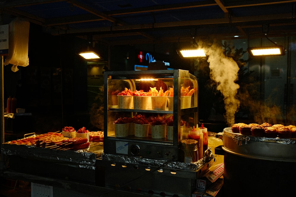 a kitchen filled with lots of food cooking on top of a stove