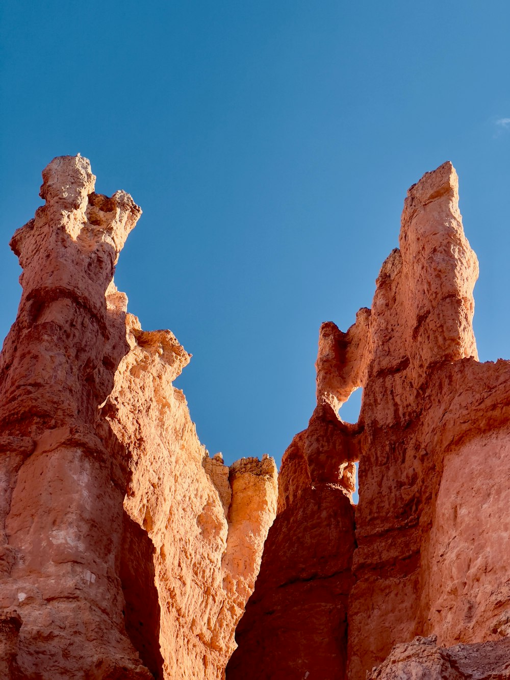 a rock formation with a blue sky in the background